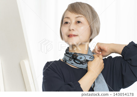 Senior women choosing scarves to dress stylishly Senior women choosing scarves to dress stylishly 143054178
