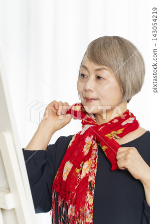Senior women choosing scarves to dress stylishly Senior women choosing scarves to dress stylishly 143054219