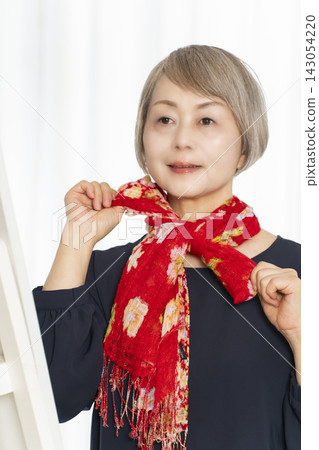 Senior women choosing scarves to dress stylishly Senior women choosing scarves to dress stylishly 143054220