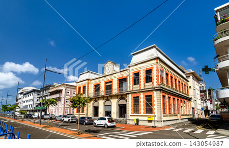 The historic old post office building featuring yellow and red architecture under a blue sky in Fort-de-France, Martinique The historic old post office building featuring yellow and red architecture under a blue sky in Fort-de-France, Martinique 143054987
