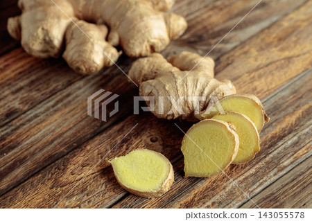 Ginger root on an old wooden table. Ginger root on an old wooden table. 143055578