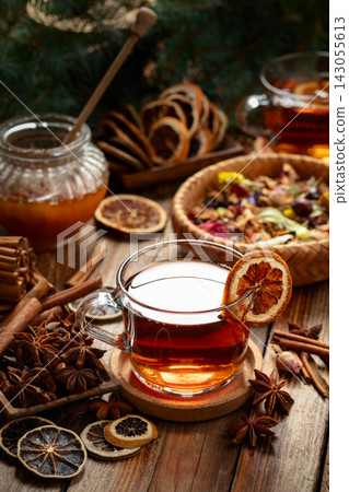 Christmas herbal tea with ingredients on a old wooden table. Christmas herbal tea with ingredients on a old wooden table. 143055613