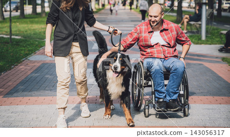 Happy young man with a physical disability in a wheelchair with his dog. Happy young man with a physical disability in a wheelchair with his dog. 143056317