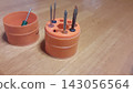 A small screwdriver in a unique drum-shaped case. 143056564