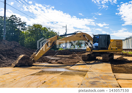Construction site, heavy equipment, backhoe Construction site, heavy equipment, backhoe 143057530
