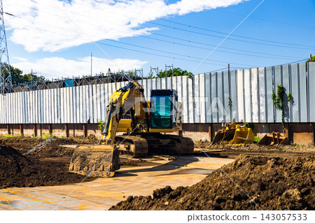 Construction site, heavy equipment, backhoe Construction site, heavy equipment, backhoe 143057533