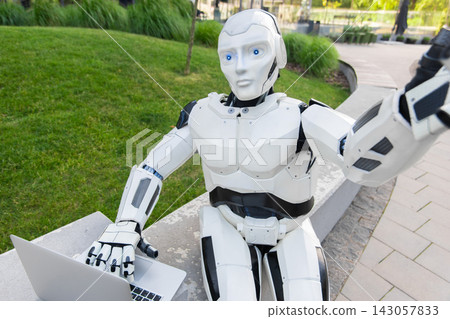 Futuristic android holding laptop and taking selfie Futuristic android holding laptop and taking selfie 143057833