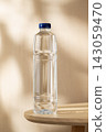 Bottled Drinking Water on a Wooden Table in Warm Natural Light with a Clean Minimalist Setting 143059470