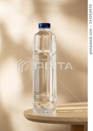 Bottled Drinking Water on a Wooden Table in Warm Natural Light with a Clean Minimalist Setting Bottled Drinking Water on a Wooden Table in Warm Natural Light with a Clean Minimalist Setting 143059470
