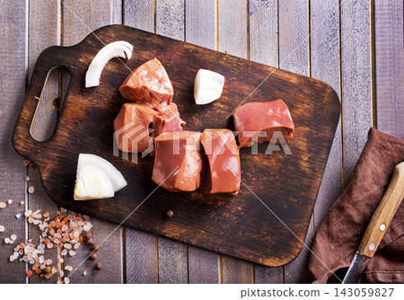 Raw beef liver on skewers on wooden board Raw beef liver on skewers on wooden board 143059827