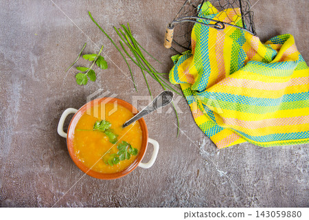 pumpkin soup in a white bowl, vegan soup pumpkin soup in a white bowl, vegan soup 143059880