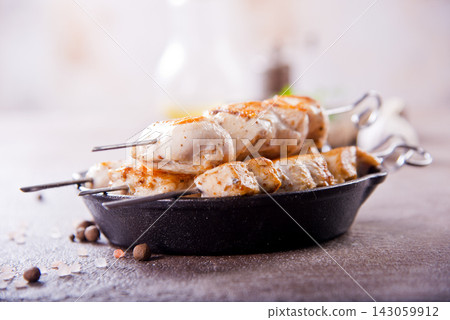 Chicken kebabs with spice on a table Chicken kebabs with spice on a table 143059912