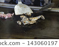 Grilling the oysters for oyster okonomiyaki Grilling the oysters for oyster okonomiyaki 143060197