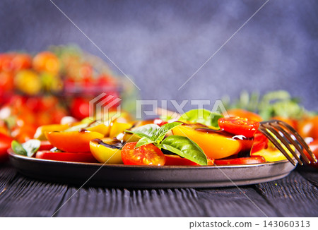 Mix colorful tomatoes with sauce on plate Mix colorful tomatoes with sauce on plate 143060313