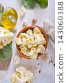 Head of cauliflower sits on a light table 143060388