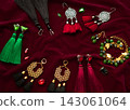 Handmade set of green,golden,black,silver and vinous bijouterie with gems, tassels, cryslals and beads, lying on the vinous velvet background, top flat view with empty place for your text 143061064