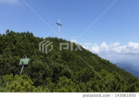 Summit cross Herzogstand mountain in Bavaria, Germany Summit cross Herzogstand mountain in Bavaria, Germany 143061850