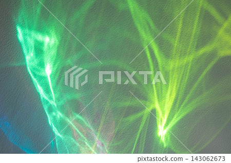 Abstract green and blue light reflections on a textured wall creating vibrant motion and pattern Abstract green and blue light reflections on a textured wall creating vibrant motion and pattern 143062673