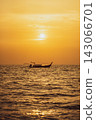 A long-tailed ship in the distance under the sunset over the Phi Phi Islands 143066701