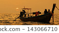 The long-tailed boat and the silhouettes of passengers at sunset over the Phi Phi Islands. 143066710