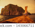The cliffs and bow of the Phi Phi Islands bathed in the setting sun 143066711