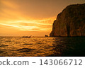 The rocky islands of the Phi Phi Islands and the fiery sunset sky 143066712
