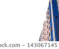 Walls of multi-storey building during construction and installation of new plastic windows isolated with copy space on white background. Frame and masonry are not yet hidden by decorative cladding 143067145