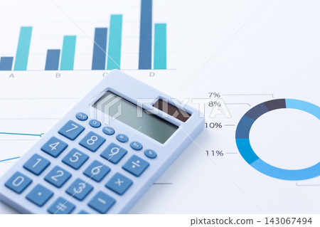 A document with a blue pie chart and a blue calculator A document with a blue pie chart and a blue calculator 143067494
