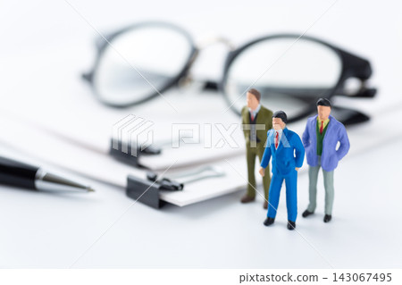 Business documents bound together with a clip and a businessman Business documents bound together with a clip and a businessman 143067495