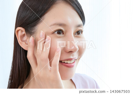 A beauty portrait of a young woman smiling naturally in profile. A beauty portrait of a young woman smiling naturally in profile. 143067503