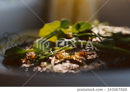 Gourmet meal with pea shoots and golden glaze Gourmet meal with pea shoots and golden glaze 143067889