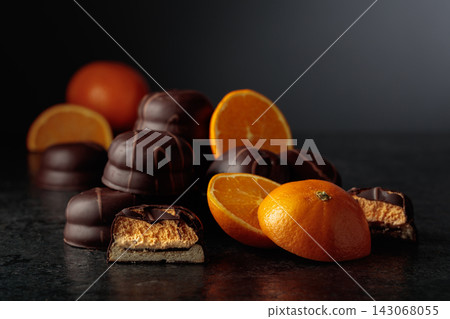 Chocolate dessert with slices of fresh oranges on a black background. Chocolate dessert with slices of fresh oranges on a black background. 143068055