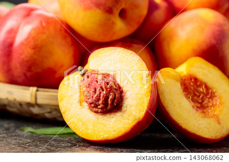 Fresh nectarines on a black stone table. 143068062