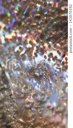Rainbow foil. Blur shiny texture. Defocused holographic purple blue color water bubbles on abstract bokeh illuminated art background. 143070392