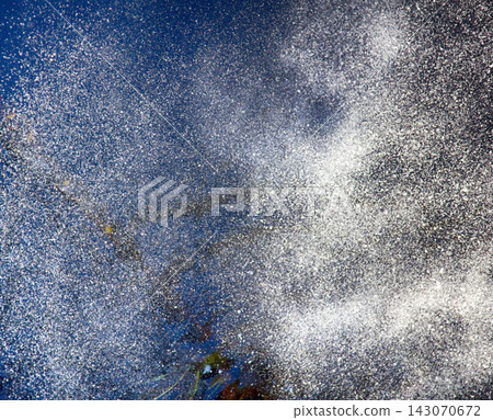 Spray of water in evening sky 143070672