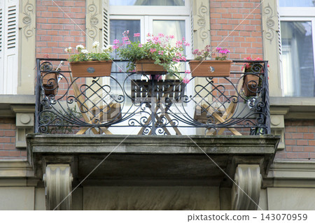 Cozy balcony with sun loungers and flower vases Cozy balcony with sun loungers and flower vases 143070959