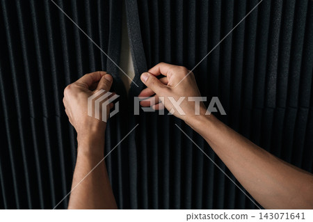 Hands carefully arranging black acoustic foam panels, creating a sound diffused wall surface for optimal audio quality in a recording studio, podcast room, or home setup. Hands carefully arranging black acoustic foam panels, creating a sound diffused wall surface for optimal audio quality in a recording studio, podcast room, or home setup. 143071641