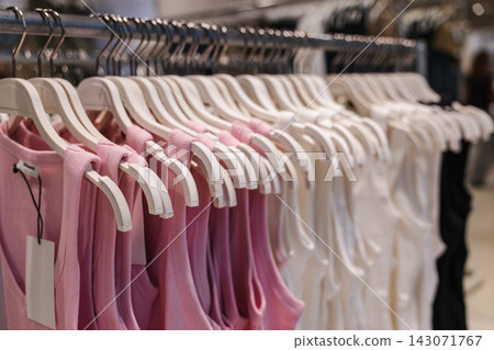 Pink and White Dresses on a Clothing Rack Pink and White Dresses on a Clothing Rack 143071767