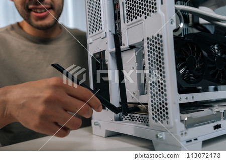 Cropped shot of male installing wireless network adapter antenna into personal computer, providing faster internet connection and enhancing data transmission for digital content. Cropped shot of male installing wireless network adapter antenna into personal computer, providing faster internet connection and enhancing data transmission for digital content. 143072478