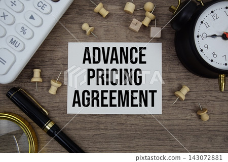 Advance Pricing Agreement text written on notepad with pen, alarm clock, magnifying glass and calculator on wooden background Advance Pricing Agreement text written on notepad with pen, alarm clock, magnifying glass and calculator on wooden background 143072881
