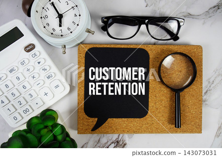 Customer Retention text with calculator and magnifying glass on marble background Customer Retention text with calculator and magnifying glass on marble background 143073031