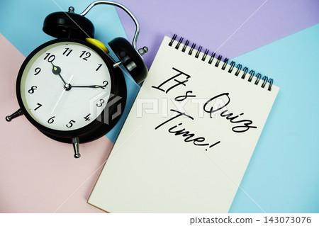 It's Quiz Time! text written on notepad with alarm clock flat lay on multicolor pastel background It's Quiz Time! text written on notepad with alarm clock flat lay on multicolor pastel background 143073076