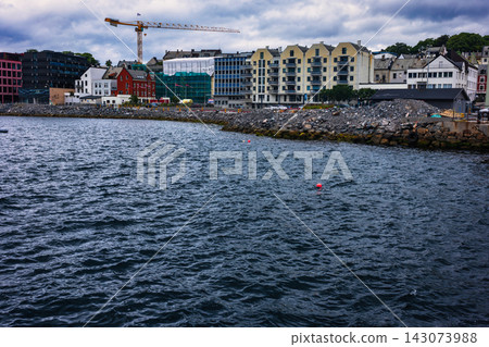 Coastal construction site with residential buildings and crane, Norway waterfront development Coastal construction site with residential buildings and crane, Norway waterfront development 143073988