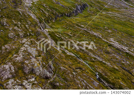 Aerial view of moss-covered mountainside with exposed bedrock and waterfalls, Rauma Norway Aerial view of moss-covered mountainside with exposed bedrock and waterfalls, Rauma Norway 143074002