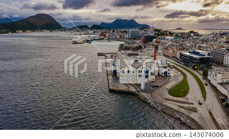 Aerial view of Alesund harbor with cruise ship and coastal town, Fjelltun, Norway Aerial view of Alesund harbor with cruise ship and coastal town, Fjelltun, Norway 143074006