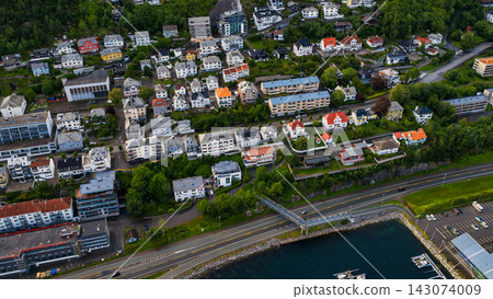 Aerial view of Fjelltun residential area, Alesund Norway with waterfront road and harbor 143074009