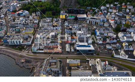 Aerial view of Slinningen waterfront district, Alesund Norway with harbor road and residential buildings 143074013