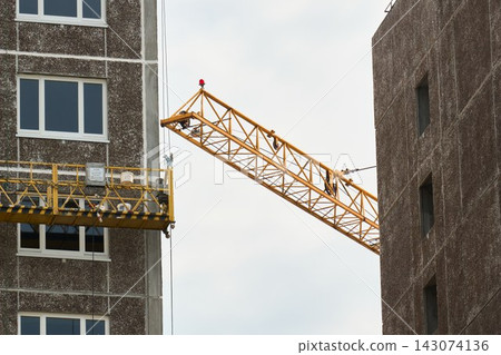 Construction Scaffolding Cradle and Tower Crane Jib Close Up Construction Scaffolding Cradle and Tower Crane Jib Close Up 143074136