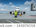 Airplane marshalling at the airport. Passenger aircraft meeting 143074158