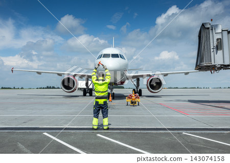 Airplane marshalling at the airport. Passenger aircraft meeting 143074158
